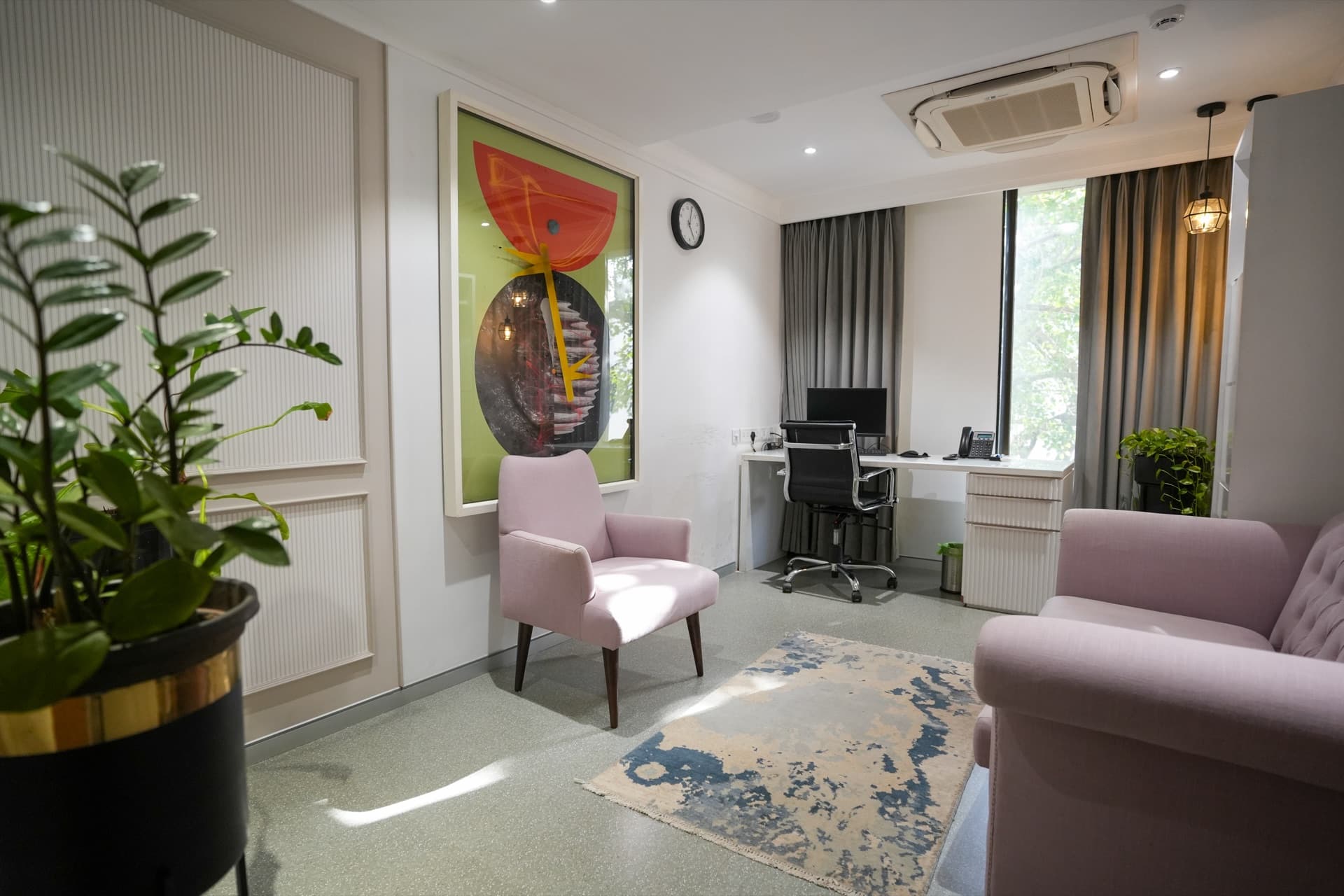 A sunlit Samarpan Health consultation room with soft armchairs, plants and artwork